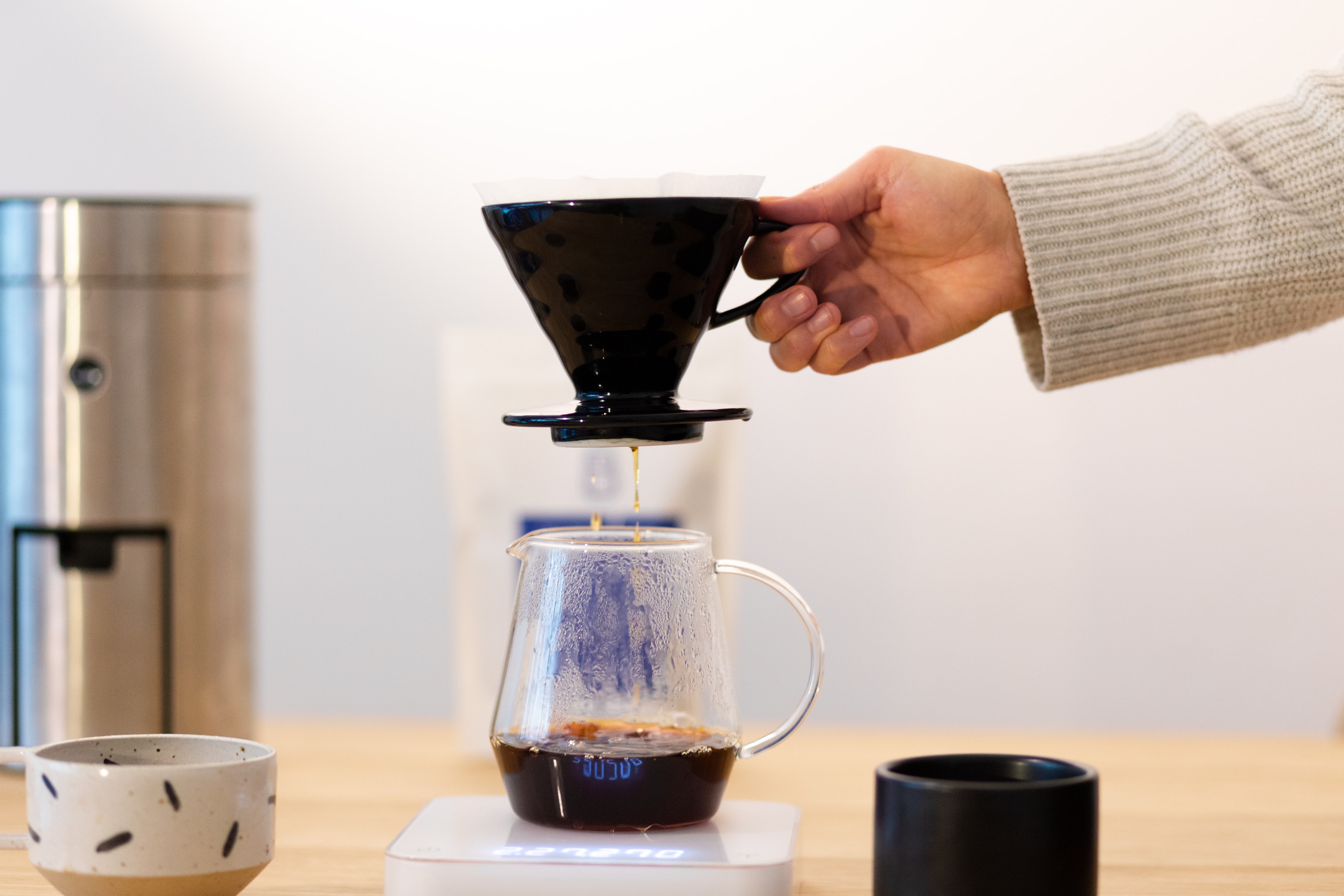 person pouring coffee on coffee